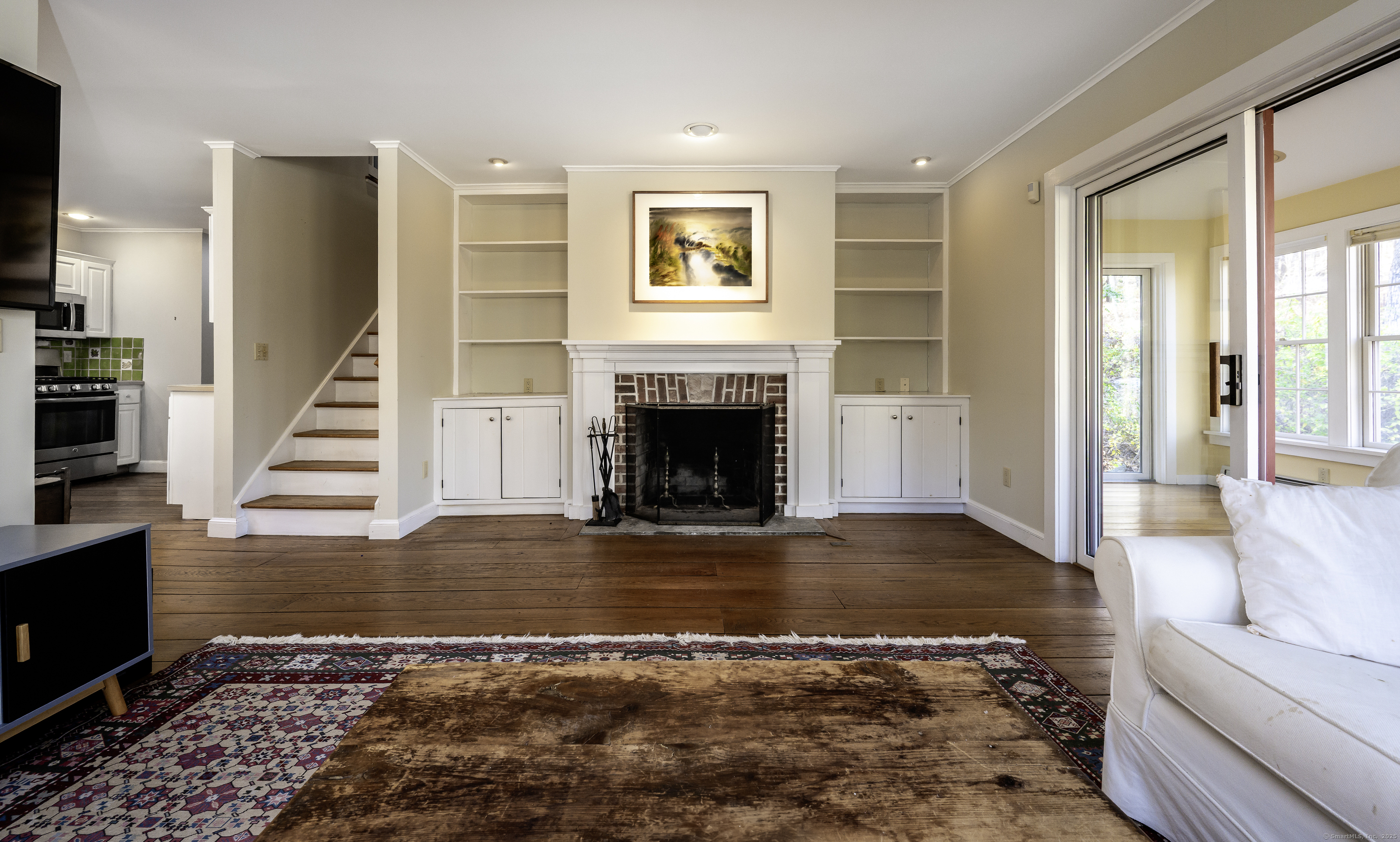 103 Geer Mountain Road South Kent, CT 06785 - Photo 16 of 36 a view of a livingroom with wooden floor and a fireplace