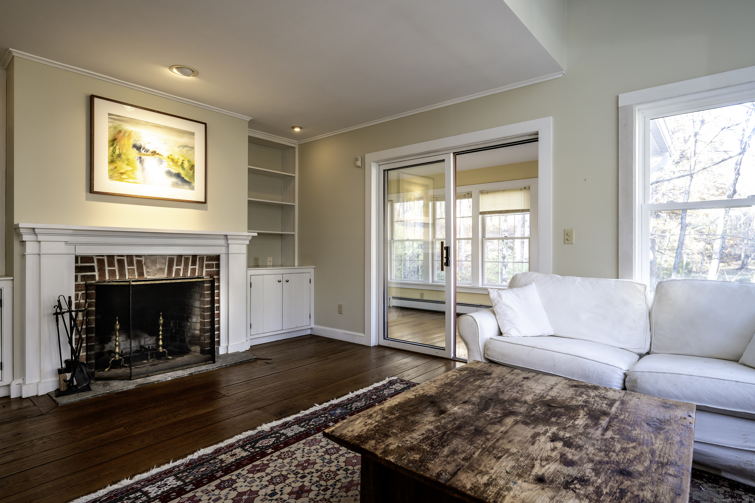 103 Geer Mountain Road South Kent, CT 06785 - Photo 17 of 36 a living room with furniture and a fireplace