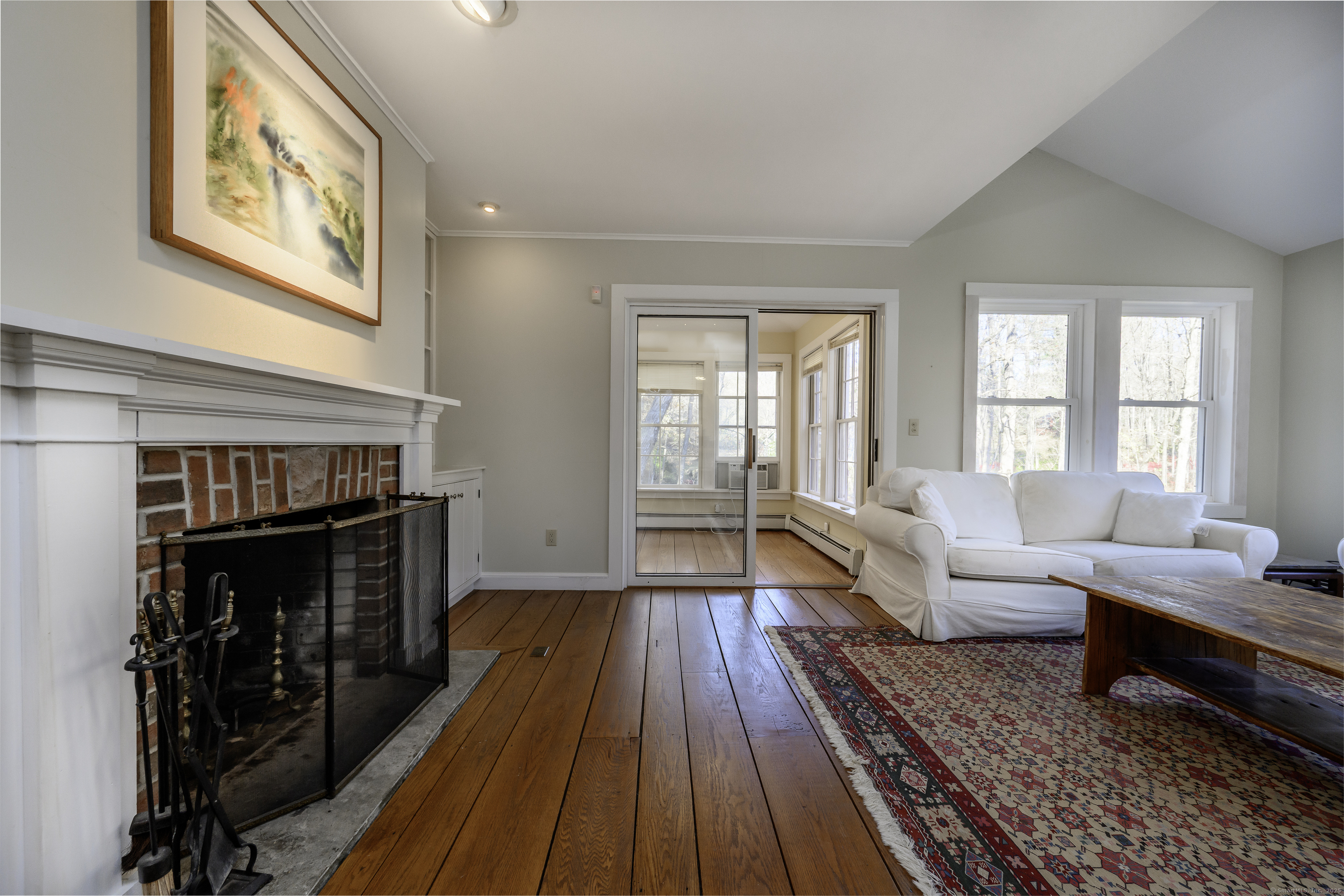 103 Geer Mountain Road South Kent, CT 06785 - Photo 19 of 36 a living room with furniture and a fireplace