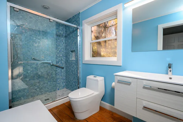 a bathroom with a toilet a sink and a shower