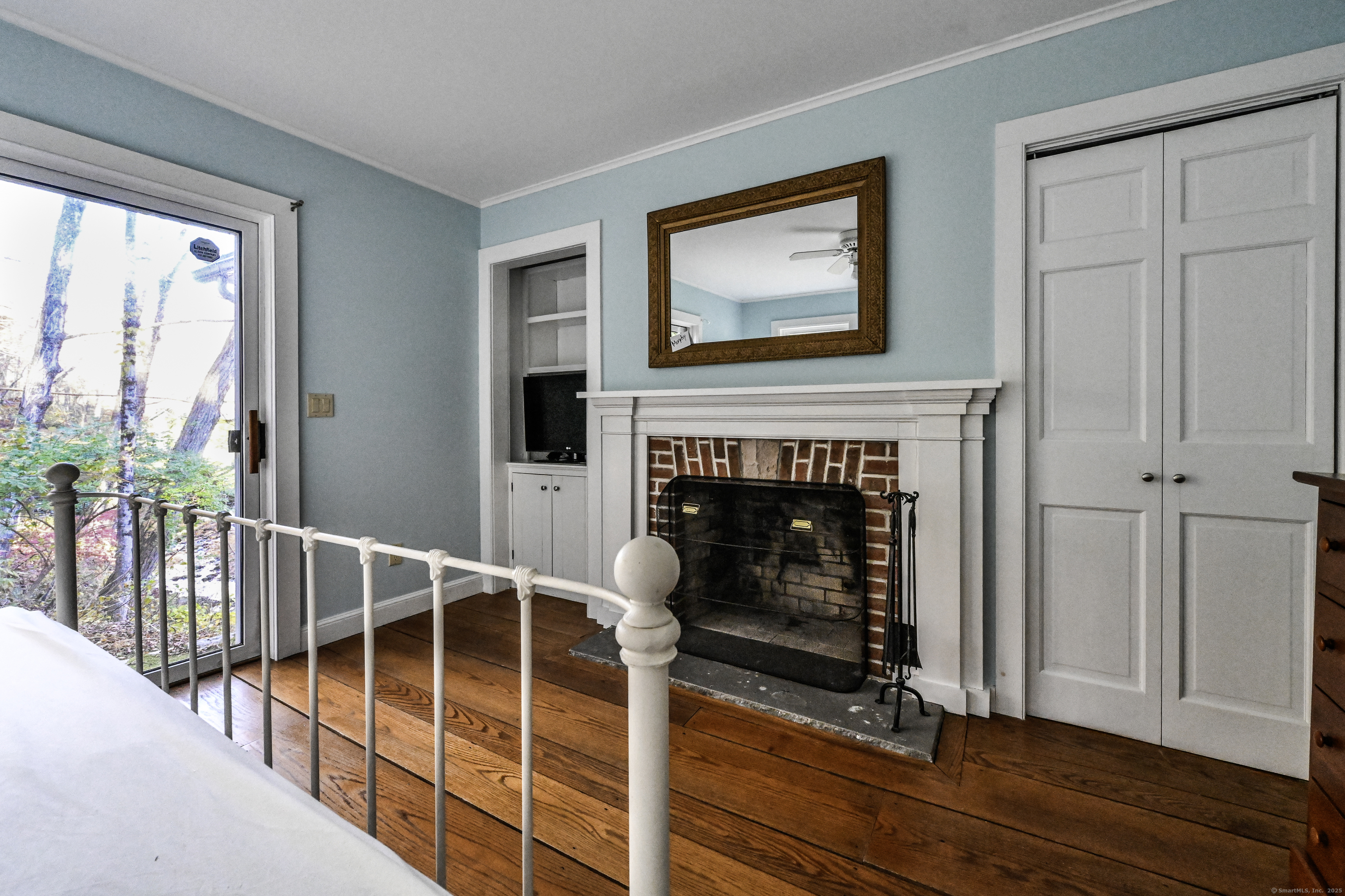 103 Geer Mountain Road South Kent, CT 06785 - Photo 21 of 36 a view of a livingroom with wooden floor and a fireplace