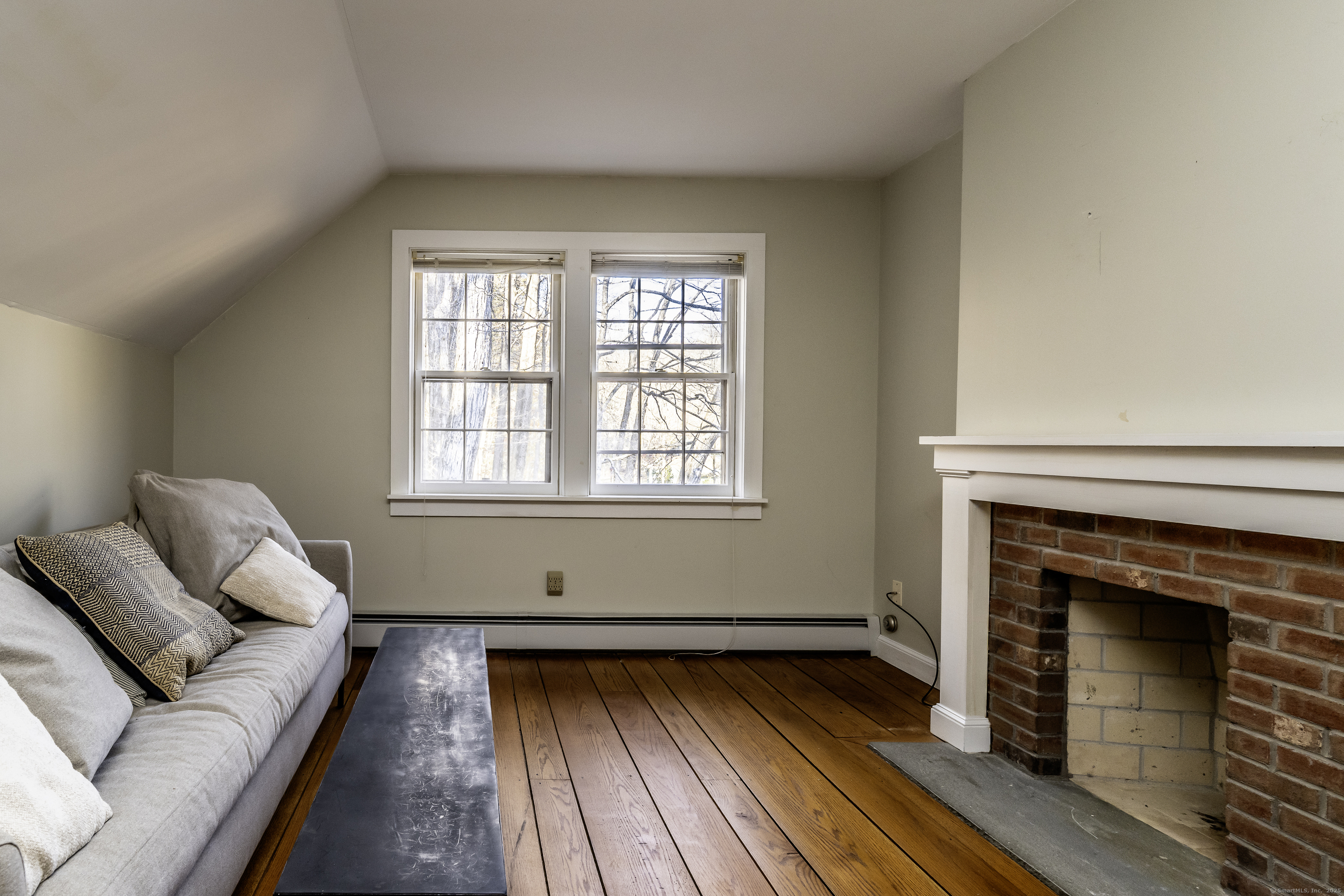 103 Geer Mountain Road South Kent, CT 06785 - Photo 22 of 36 a living room with furniture and a fireplace