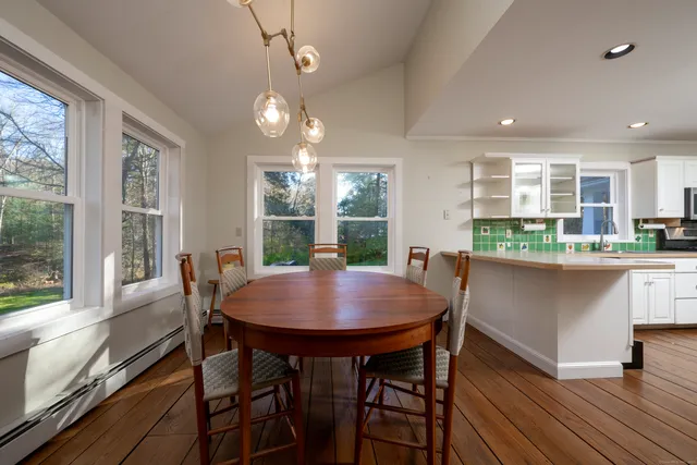 a dining room with furniture a rug and wooden floor