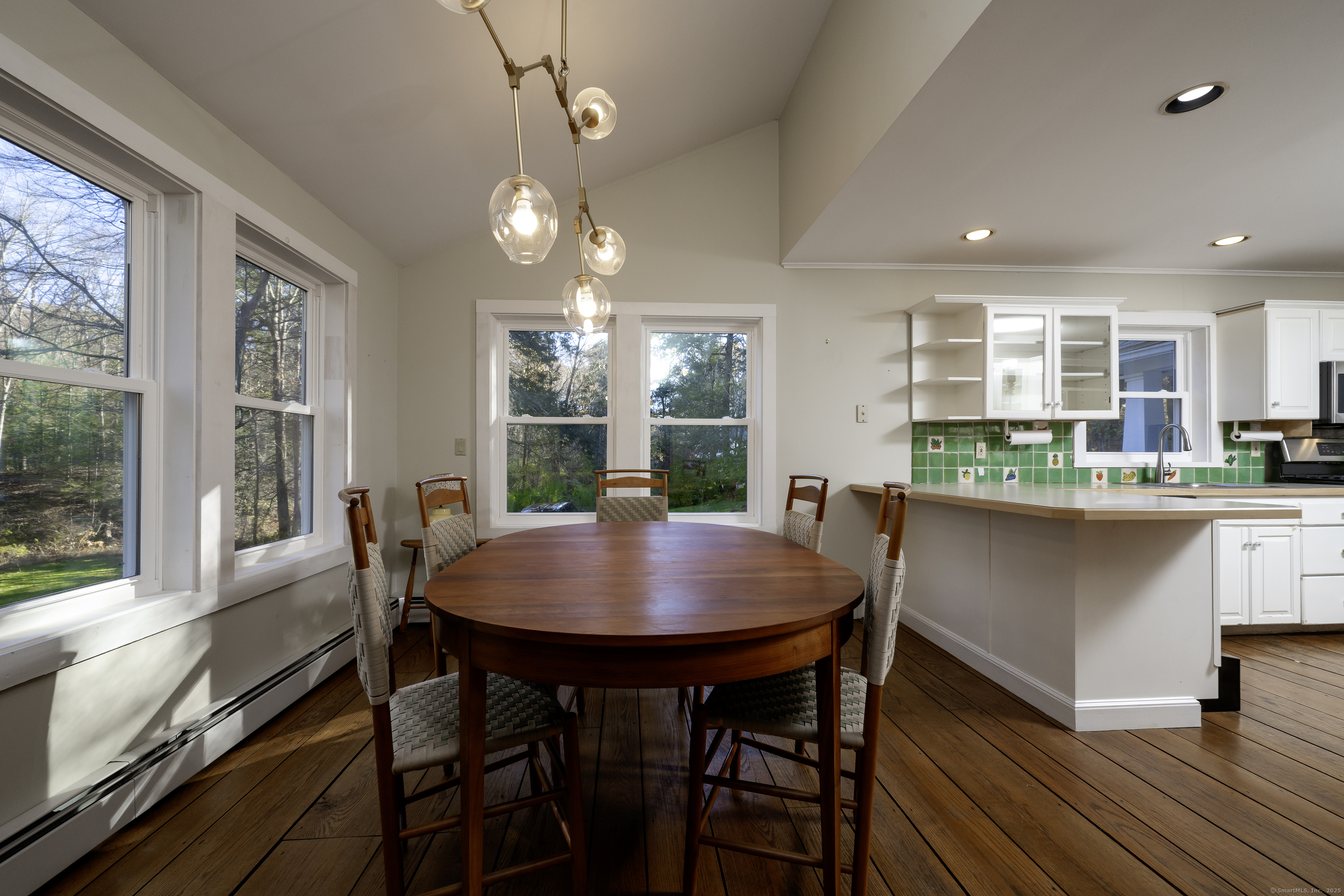 103 Geer Mountain Road South Kent, CT 06785 - Photo 28 of 36 a dining room with furniture a rug and wooden floor