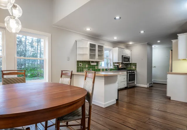 a kitchen with a table and chairs in it