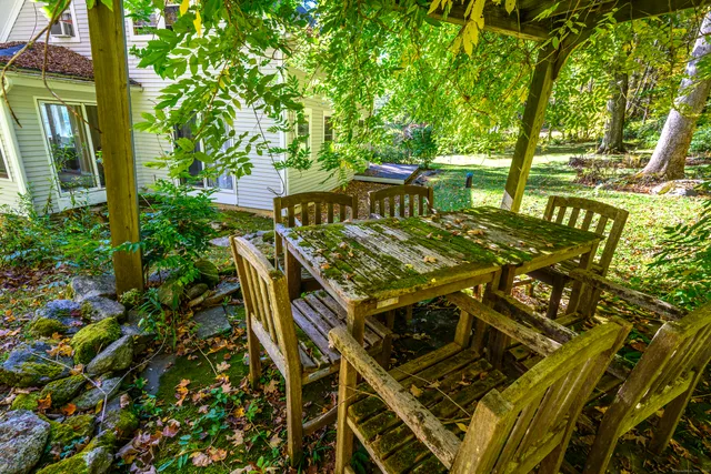 a view of a patio with table and chairs and potted plants