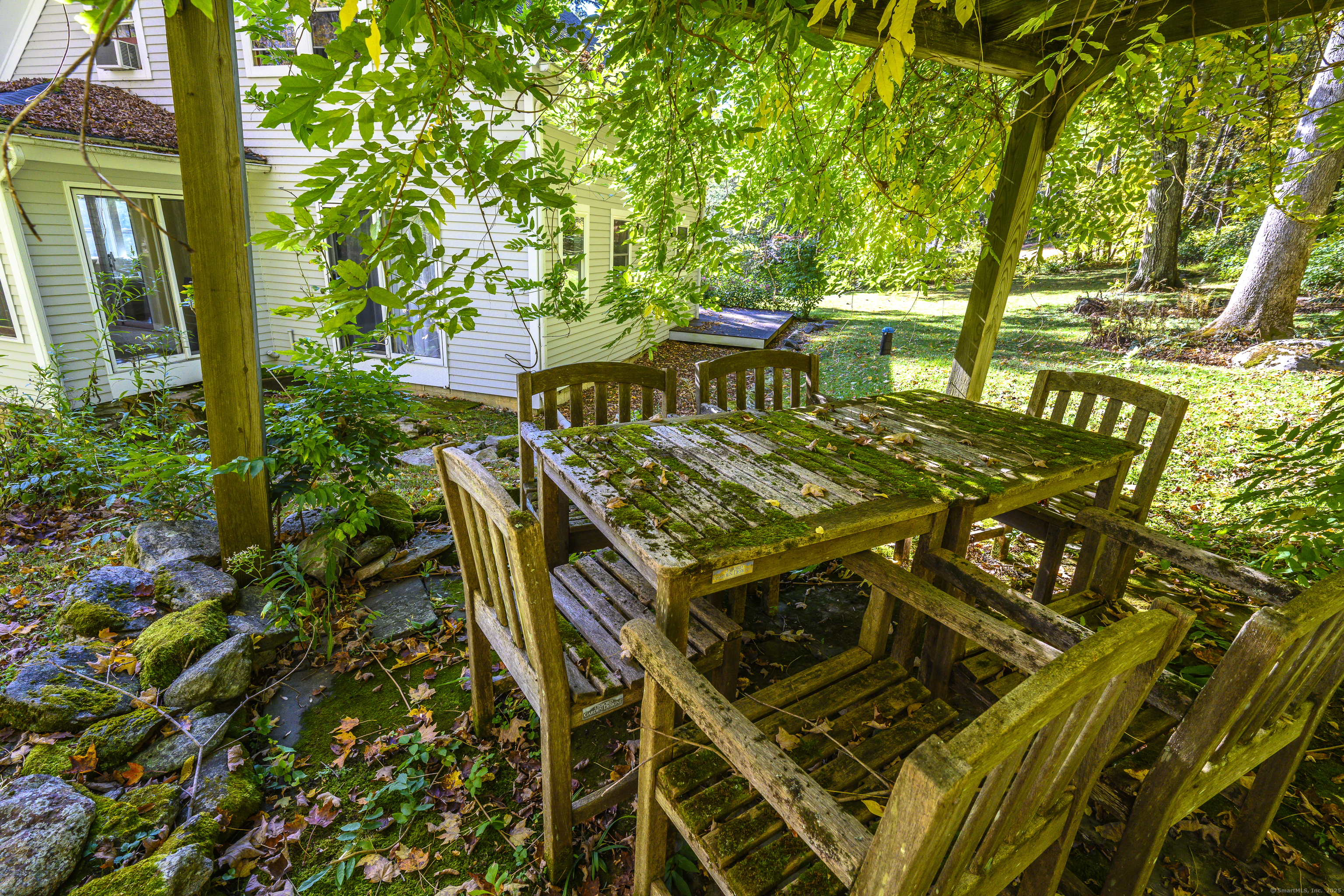 103 Geer Mountain Road South Kent, CT 06785 - Photo 32 of 36 a view of a patio with table and chairs and potted plants