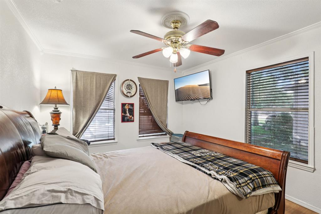 408 Harrison Lane Hurst, TX 76053 - Photo 11 of 15 a bed room with a bed and a chandelier