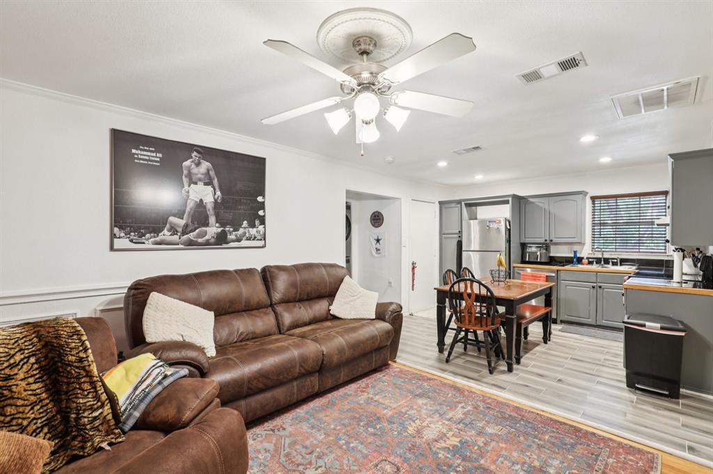 408 Harrison Lane Hurst, TX 76053 - Photo 4 of 15 a living room with furniture a dining table and kitchen view