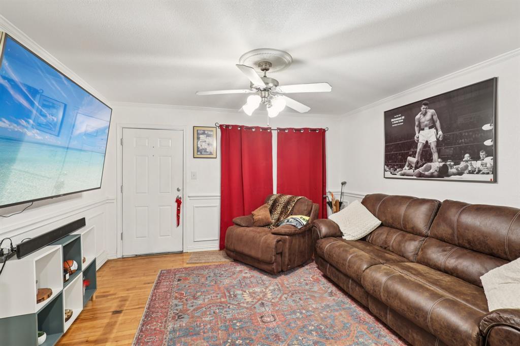 408 Harrison Lane Hurst, TX 76053 - Photo 5 of 15 a living room with furniture a fireplace and a chandelier