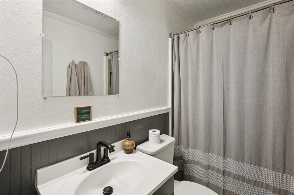 408 Harrison Lane Hurst, TX 76053 - Photo 8 of 15 a bathroom with a sink and a mirror