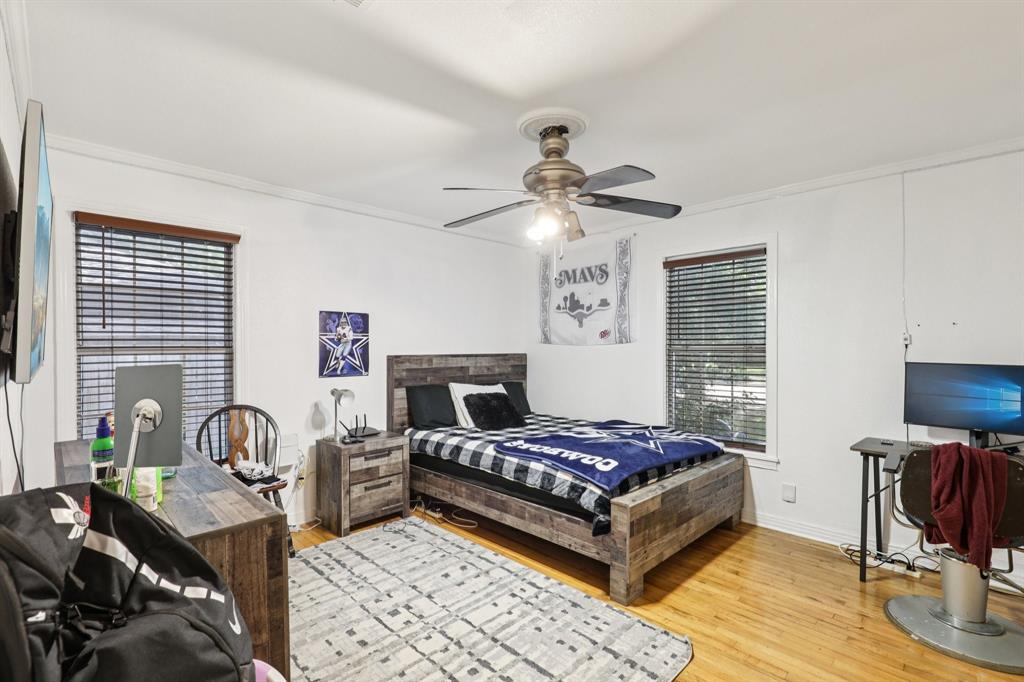 408 Harrison Lane Hurst, TX 76053 - Photo 9 of 15 a bedroom with a bed and a chandelier