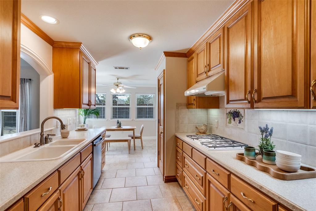 6604 Villa Road Dallas, TX 75252 - Photo 11 of 28 a kitchen with stainless steel appliances a sink stove and cabinets