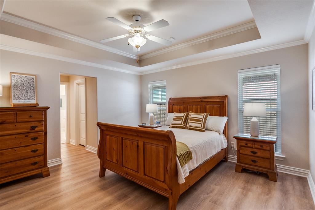 6604 Villa Road Dallas, TX 75252 - Photo 16 of 28 a bedroom with a bed and a chandelier