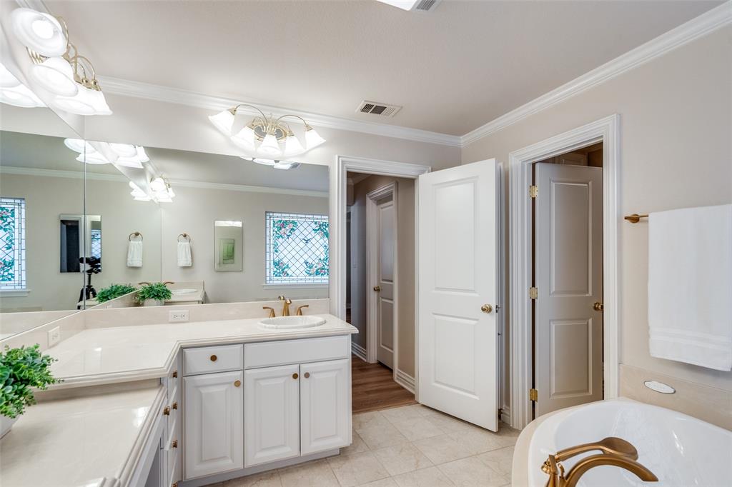 6604 Villa Road Dallas, TX 75252 - Photo 20 of 28 a bathroom with a double vanity sink and a mirror