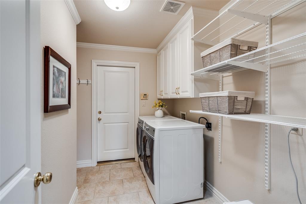 6604 Villa Road Dallas, TX 75252 - Photo 24 of 28 a utility room with cabinets washer and dryer