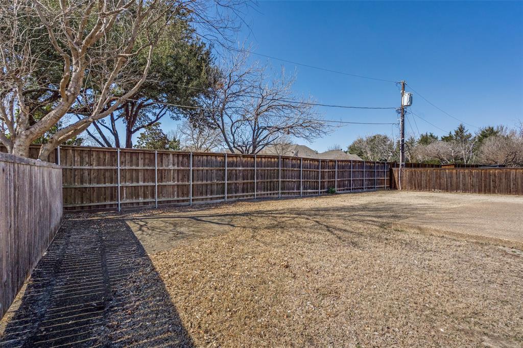 6604 Villa Road Dallas, TX 75252 - Photo 27 of 28 a view of a backyard with a fence and wooden fence