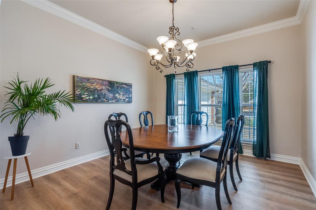 6604 Villa Road Dallas, TX 75252 - Photo 4 of 28 a view of a dining room with furniture a chandelier and wooden floor