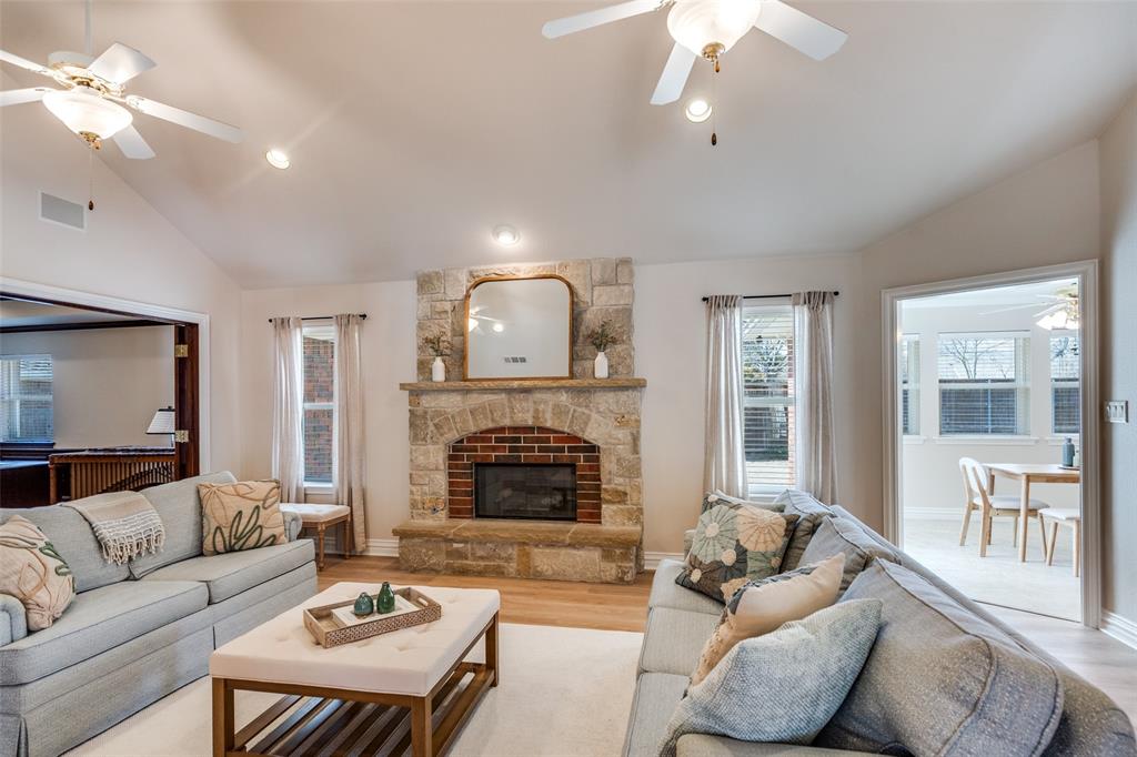6604 Villa Road Dallas, TX 75252 - Photo 9 of 28 a living room with furniture and a fireplace