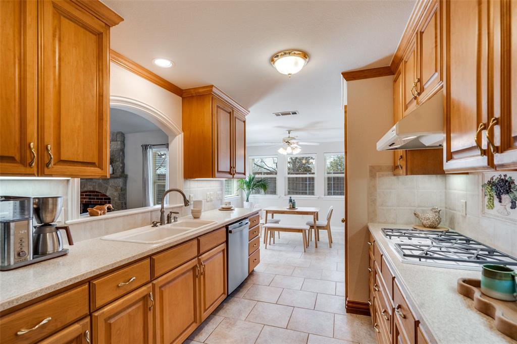 6604 Villa Road Dallas, TX 75252 - Photo 10 of 28 a large kitchen with stainless steel appliances a sink and a large window