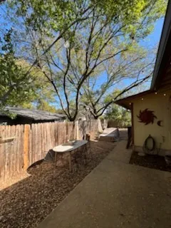 a view of backyard with wooden fence
