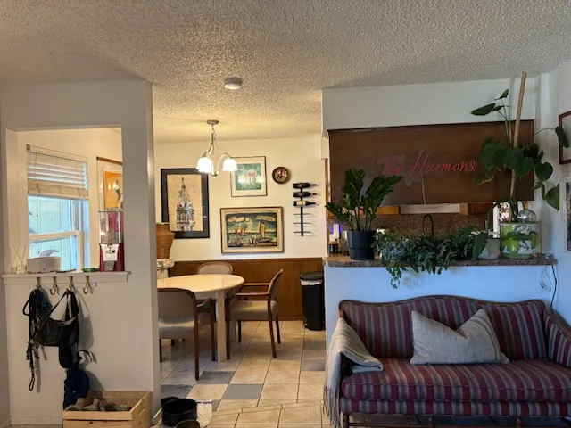 a living room with furniture kitchen view and a large window