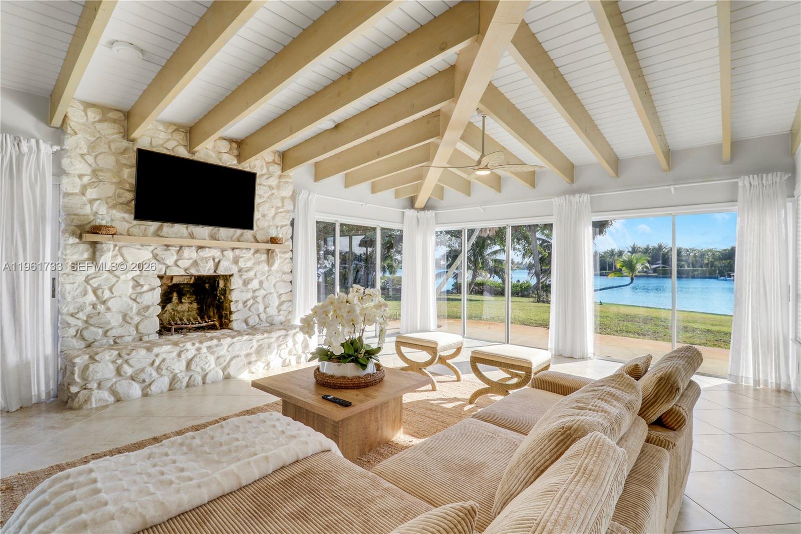 a living room with furniture a flat screen tv and a fireplace