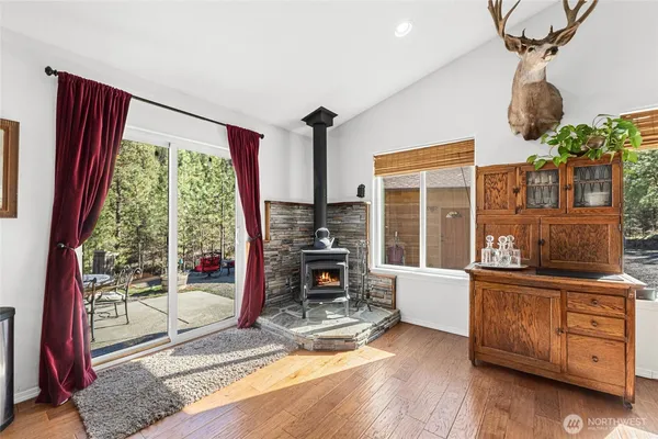 a living room with furniture a flat screen tv and a floor to ceiling window