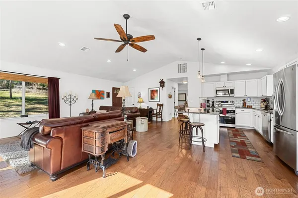 a living room with lots of furniture and kitchen view