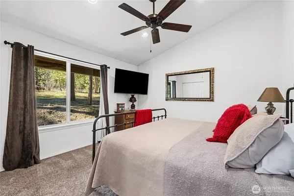 a bedroom with a bed and a flat screen tv