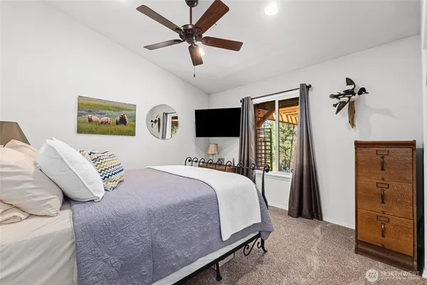 a bedroom with a large bed and a tv