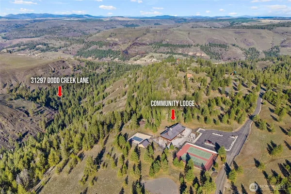 an aerial view of a house with a mountain