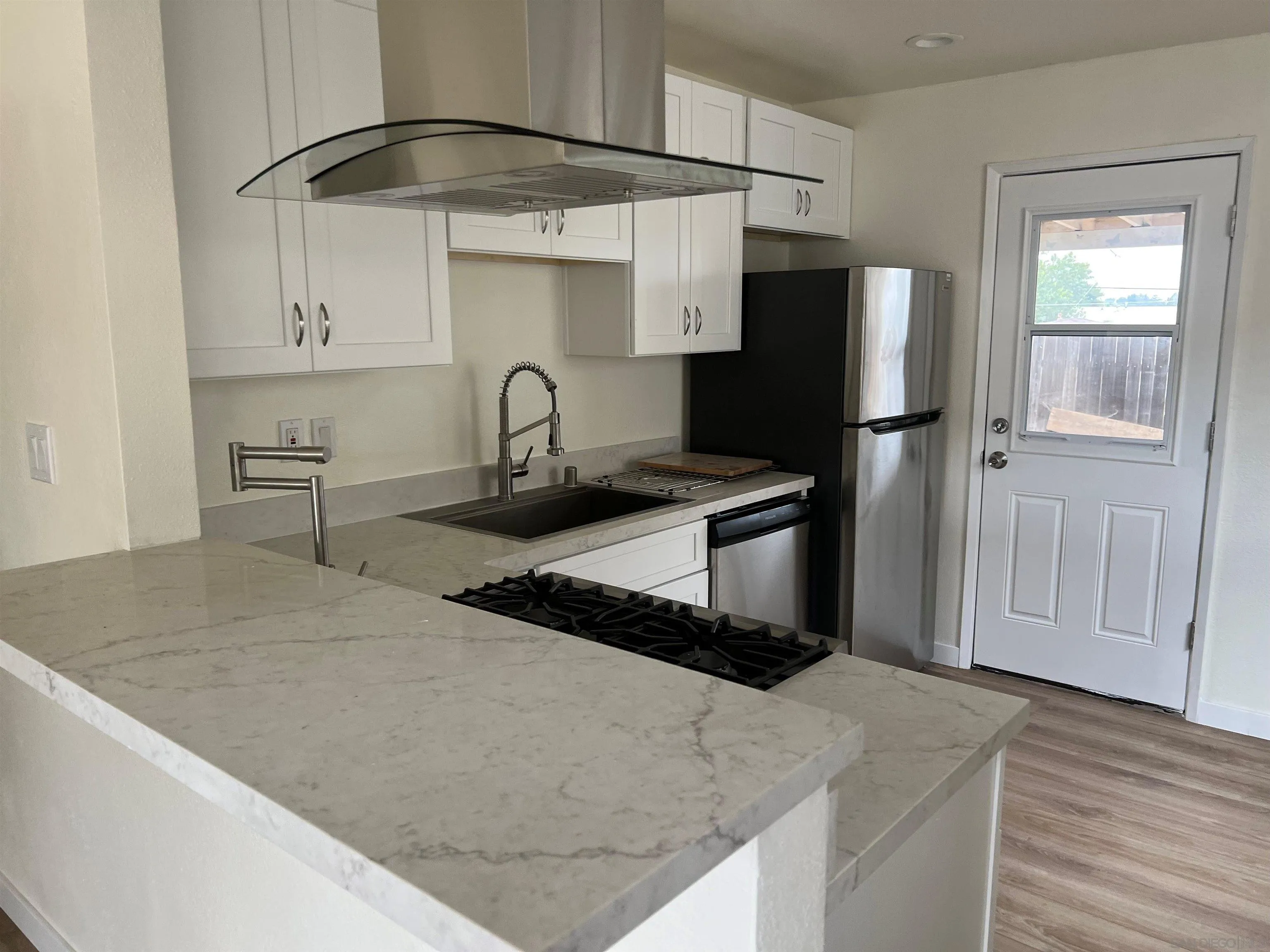 a kitchen with stainless steel appliances granite countertop a granite counter tops and a refrigerator