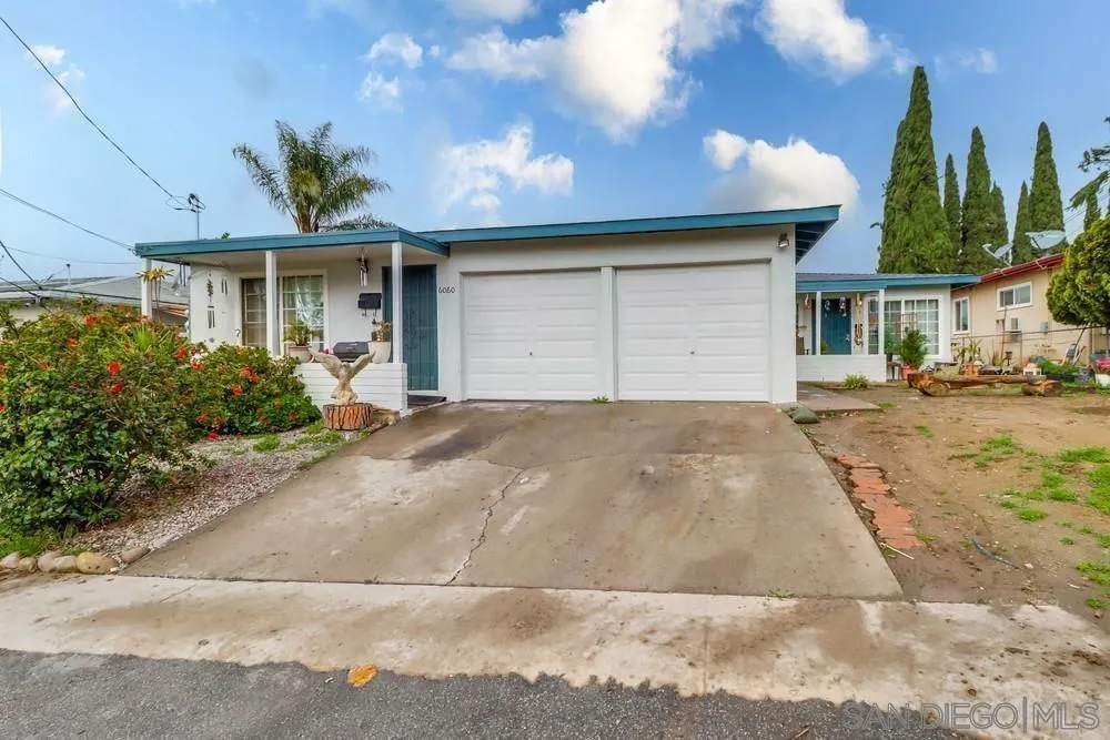 6060 Nancy Drive La Mesa, CA 91942 - Photo 3 of 9 a front view of a house with a yard and a garage