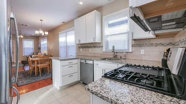 a kitchen with a stove a sink and a refrigerator