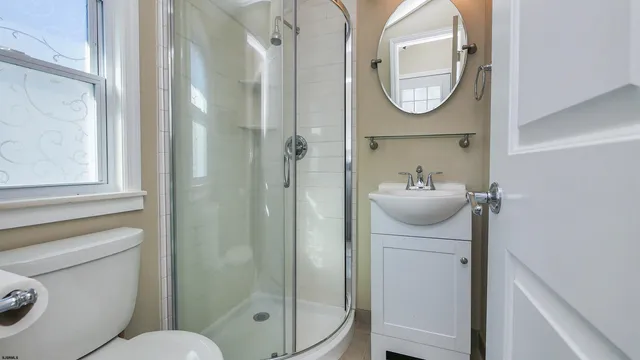 a bathroom with a toilet a sink and a mirror