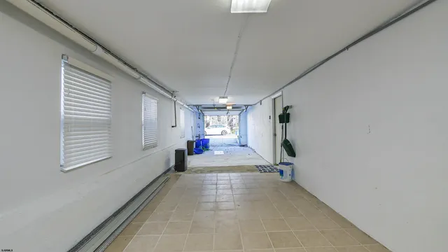 a view of empty room with wooden floor and windows