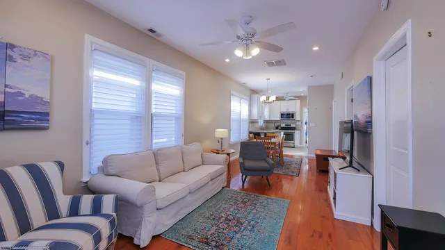 a living room with furniture and a chandelier
