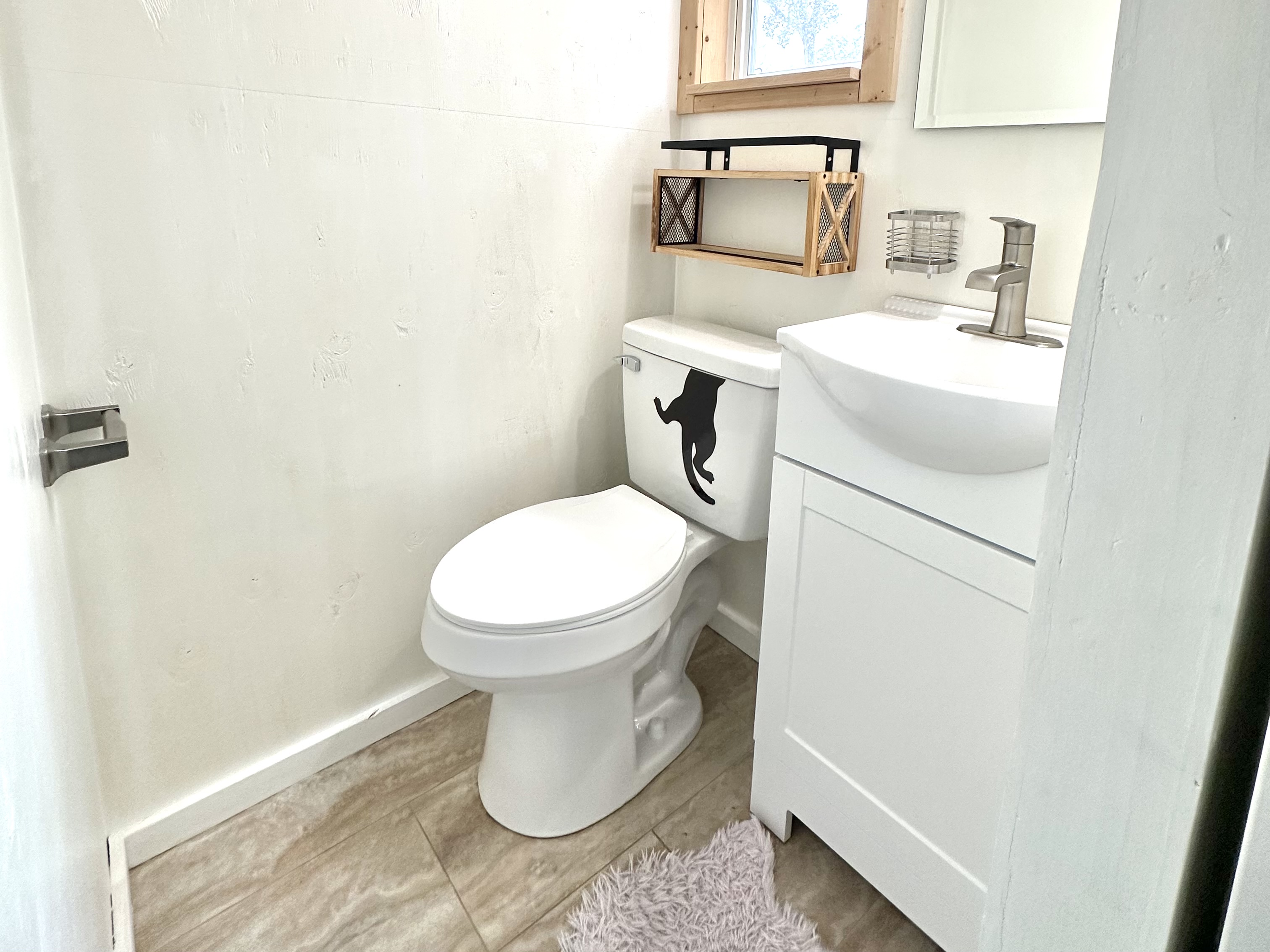 92-2083 Kailua Boulevard Ocean View, HI 96704 - Photo 12 of 30 a white toilet sitting next to a bathroom sink