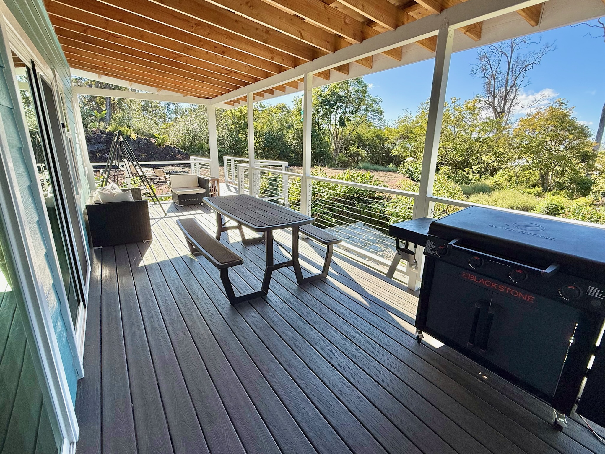 92-2083 Kailua Boulevard Ocean View, HI 96704 - Photo 16 of 30 a view of a patio with wooden floor and outdoor seating