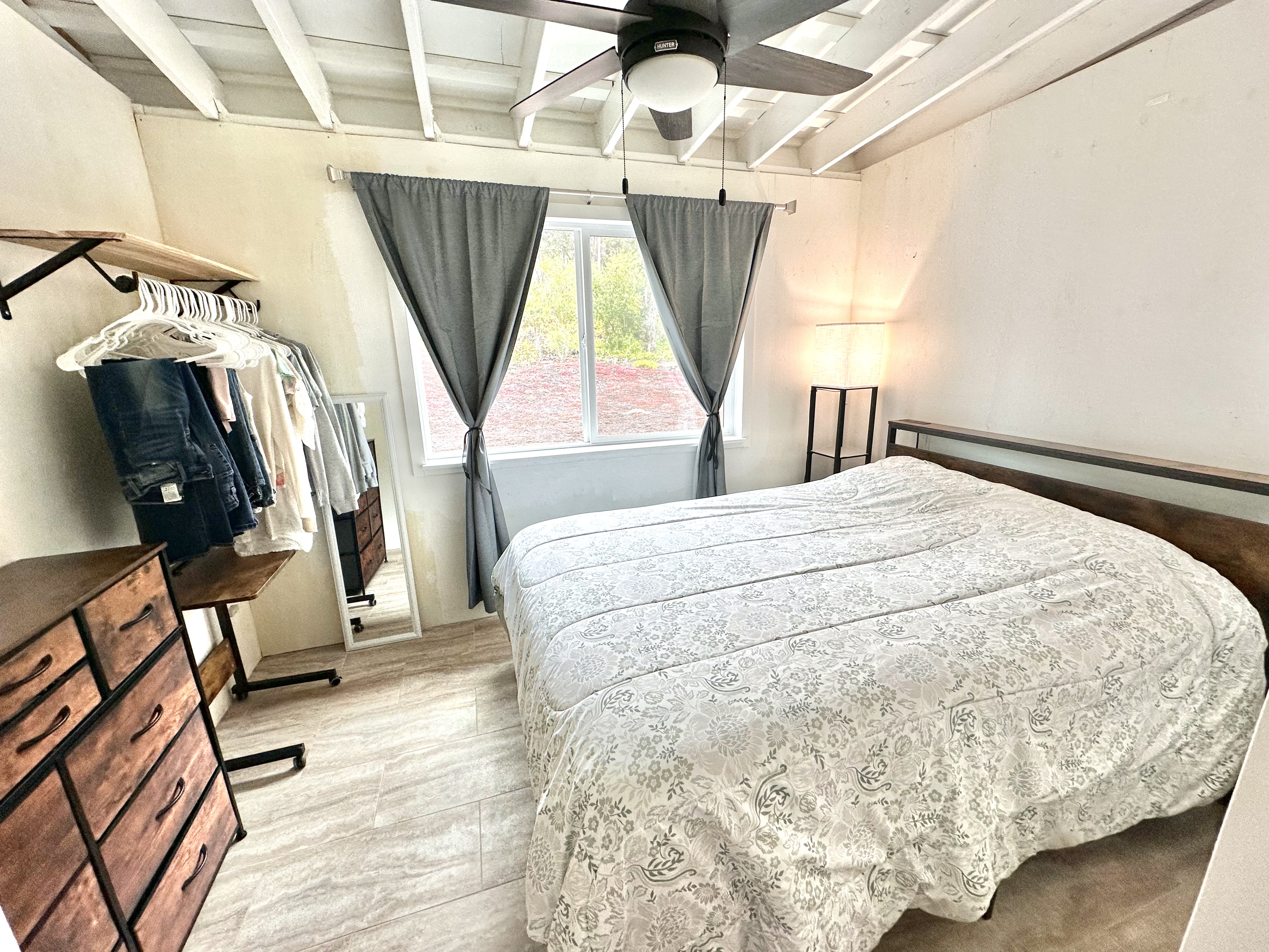 92-2083 Kailua Boulevard Ocean View, HI 96704 - Photo 19 of 30 a bed sitting in a bedroom next to a window