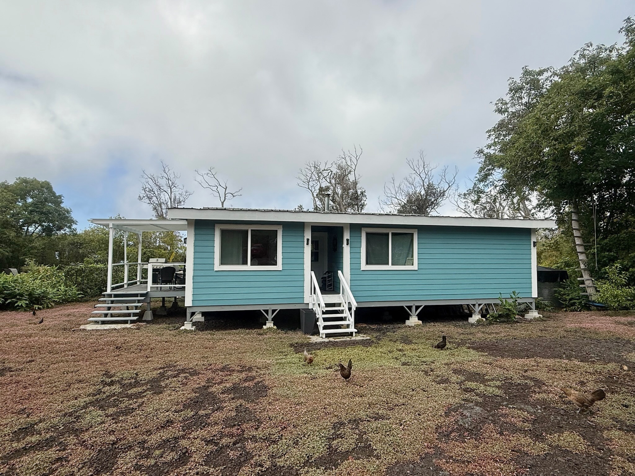 92-2083 Kailua Boulevard Ocean View, HI 96704 - Photo 2 of 30 a view of a house with a yard and furniture