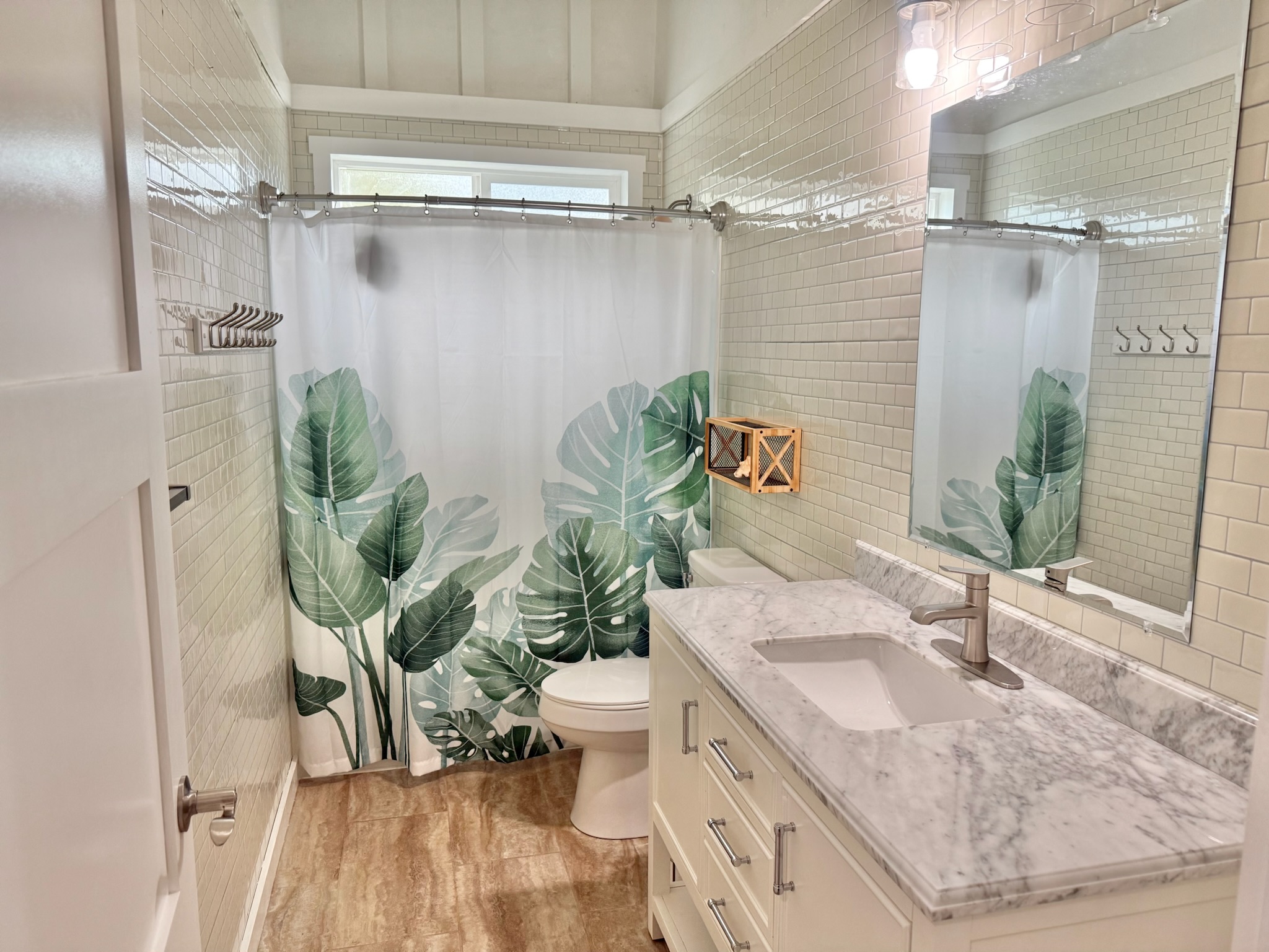 92-2083 Kailua Boulevard Ocean View, HI 96704 - Photo 8 of 30 a bathroom with a granite countertop sink a toilet and shower