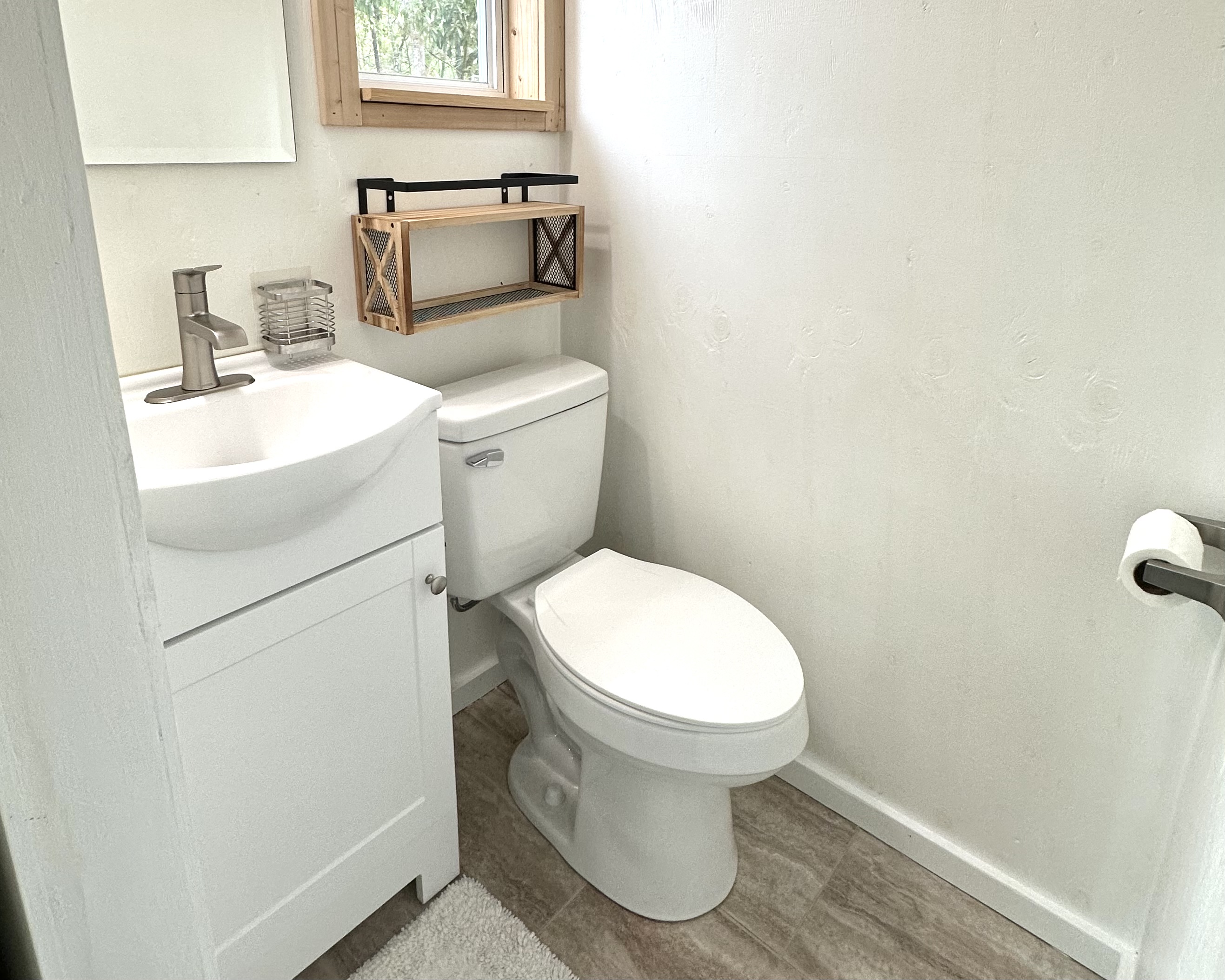 92-2083 Kailua Boulevard Ocean View, HI 96704 - Photo 10 of 30 a bathroom with a sink toilet and a mirror