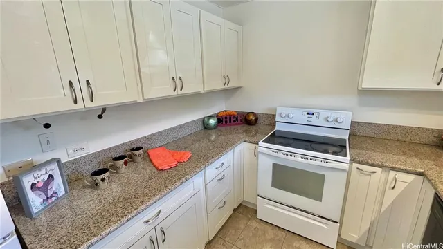 a kitchen with granite countertop cabinets and white appliances