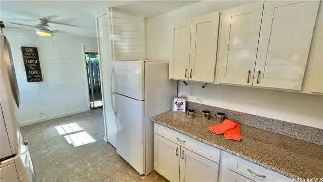a kitchen with refrigerator and cabinets