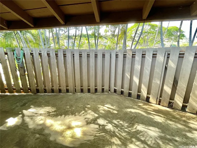 a view of a yard with wooden fence
