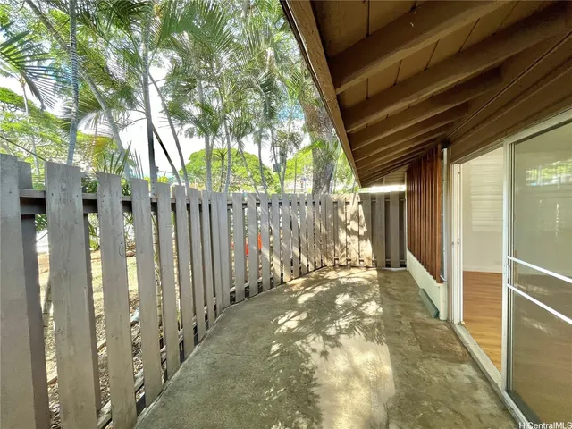 a view of a pathway of a house with wooden fence