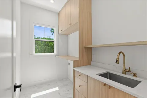 a kitchen with a sink and cabinets