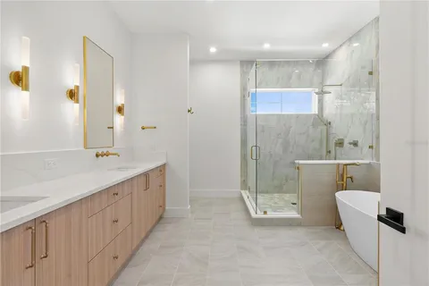 a bathroom with a double vanity sink toilet and shower